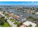 Expansive aerial view of a waterfront home surrounded by lush greenery and picturesque canals in a coastal community at 7949 2Nd S Ave, St Petersburg, FL 33707