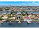 Breathtaking aerial view of a luxurious waterfront home with a private dock and stunning coastal scenery in the background at 7949 2Nd S Ave, St Petersburg, FL 33707