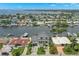 Picturesque aerial view of a waterfront home with lush landscaping and boats docked along a canal, promising a serene lifestyle at 7949 2Nd S Ave, St Petersburg, FL 33707