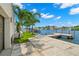 Waterfront backyard featuring a private dock, mature palms, and scenic views at 7949 2Nd S Ave, St Petersburg, FL 33707