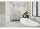 This elegant bathroom boasts a glass enclosed shower and a soaking tub at 7949 2Nd S Ave, St Petersburg, FL 33707