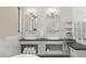 This bathroom showcases double sinks, a vanity, and marble tile surround at 7949 2Nd S Ave, St Petersburg, FL 33707