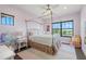 bedroom with pink walls, a four-poster bed, and water views at 7949 2Nd S Ave, St Petersburg, FL 33707