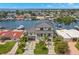Modern two-story waterfront home with meticulously kept lawn, walkway, and lush palm trees at 7949 2Nd S Ave, St Petersburg, FL 33707