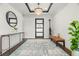Inviting foyer with dark hardwood floors, modern decor, a stylish rug, and an eye-catching light fixture at 7949 2Nd S Ave, St Petersburg, FL 33707