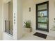 Close-up of a modern front door with address numbers, modern railing, and clean landscaping at 7949 2Nd S Ave, St Petersburg, FL 33707