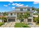 Beautiful two-story home with a modern design, a well-manicured lawn, lush landscaping, and a multi-car garage at 7949 2Nd S Ave, St Petersburg, FL 33707