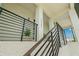 Close up of a front porch with stairs, modern railing and address numbers at 7949 2Nd S Ave, St Petersburg, FL 33707