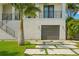 A contemporary home features a two-car garage with modern design elements and clean lines at 7949 2Nd S Ave, St Petersburg, FL 33707