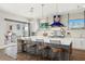 Gourmet kitchen features a large island with seating, stainless steel appliances, and sliding doors to the outside at 7949 2Nd S Ave, St Petersburg, FL 33707