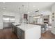 Spacious open-concept kitchen featuring a large island, stainless steel appliances, and modern pendant lighting at 7949 2Nd S Ave, St Petersburg, FL 33707