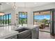 Open kitchen boasts stainless steel appliances, a center island with sink, and access to an outdoor balcony at 7949 2Nd S Ave, St Petersburg, FL 33707