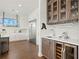 Elegant kitchenette area features custom cabinetry, stainless steel appliances, and a built-in wine cooler at 7949 2Nd S Ave, St Petersburg, FL 33707