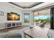 Stylish living room featuring coffered ceilings, large tv, and access to an outdoor patio at 7949 2Nd S Ave, St Petersburg, FL 33707