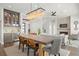 Spacious living area features a dining table, modern lighting, fireplace, and a beverage bar at 7949 2Nd S Ave, St Petersburg, FL 33707
