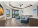 Bright living room with tray ceiling, hardwood floors, and sliding glass doors to outdoor balcony at 7949 2Nd S Ave, St Petersburg, FL 33707