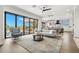 Open-concept living room featuring a large glass sliding door, modern furnishings, and stylish rug at 7949 2Nd S Ave, St Petersburg, FL 33707