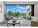 Chic living room featuring modern decor and a large open window with stunning pool and waterfront views at 7949 2Nd S Ave, St Petersburg, FL 33707