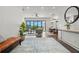 Bright living room boasts hardwood floors, a ceiling fan, and sliding glass doors leading to an outdoor view at 7949 2Nd S Ave, St Petersburg, FL 33707