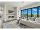 Comfortable living room features a modern fireplace, TV, and sliding glass doors with an outdoor view and pool at 7949 2Nd S Ave, St Petersburg, FL 33707
