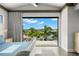 Main bedroom features a pool view with an open door to a balcony at 7949 2Nd S Ave, St Petersburg, FL 33707