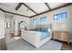 Spacious main bedroom with a statement mirror, ceiling beams and multiple windows allowing natural light at 7949 2Nd S Ave, St Petersburg, FL 33707