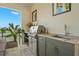 Well-equipped outdoor kitchen featuring granite countertops, stainless steel grill and fixtures, and storage space at 7949 2Nd S Ave, St Petersburg, FL 33707