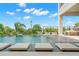Tranquil infinity pool and waterfront view are complimented by a luxurious patio space at 7949 2Nd S Ave, St Petersburg, FL 33707