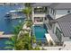 Aerial shot of the rear exterior of a modern two-story home showing the pool, outdoor seating, and waterfront views at 7949 2Nd S Ave, St Petersburg, FL 33707