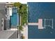 Aerial shot showcases a modern pool, a cozy seating area, and a private dock with boat lift at 7949 2Nd S Ave, St Petersburg, FL 33707
