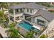 An eye-level exterior shot showcasing a modern pool with stepping stones and a spa attached to a two story home at 7949 2Nd S Ave, St Petersburg, FL 33707