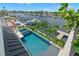 An aerial view of a private pool surrounded by lush landscaping and a dock on the waterfront at 7949 2Nd S Ave, St Petersburg, FL 33707