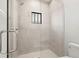 Modern tiled shower with glass door and bronze shower head at 7949 2Nd S Ave, St Petersburg, FL 33707