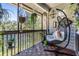 Relaxing screened balcony with hanging chair and plants at 2500 Winding Creek Blvd # D204, Clearwater, FL 33761