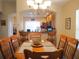 Dining room with wood table and chairs, view of kitchen at 18833 Bent Pine Dr, Hudson, FL 34667