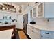 White kitchen with stainless steel appliances and glass-front upper cabinets at 5311 Boardwalk St, Holiday, FL 34690