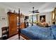 Main bedroom with four-poster bed, large armoire, and window seat at 5311 Boardwalk St, Holiday, FL 34690