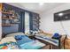 ' bedroom with twin beds, built-in shelves, and blue walls at 14929 Promenade Pkwy, Odessa, FL 33556