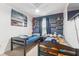 ' bedroom with twin beds, built-in shelves, and blue walls at 14929 Promenade Pkwy, Odessa, FL 33556