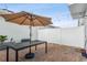Brick patio with umbrella, table, and grill at 14929 Promenade Pkwy, Odessa, FL 33556