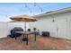 Brick patio with umbrella, table, and grill at 14929 Promenade Pkwy, Odessa, FL 33556