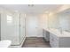 Modern bathroom with double vanity, walk-in shower, and soaking tub at 10341 Fieldstone Myrtle Way, San Antonio, FL 33576