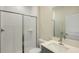 Modern bathroom with a wave patterned shower and gray vanity at 10341 Fieldstone Myrtle Way, San Antonio, FL 33576