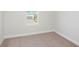 Bright bedroom with neutral carpeting and a window at 10341 Fieldstone Myrtle Way, San Antonio, FL 33576
