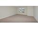 Large bedroom with neutral carpeting and two windows at 10341 Fieldstone Myrtle Way, San Antonio, FL 33576