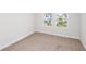 Well-lit bedroom with neutral carpet and window at 10341 Fieldstone Myrtle Way, San Antonio, FL 33576