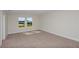 Spacious bedroom with neutral carpeting and large windows at 10341 Fieldstone Myrtle Way, San Antonio, FL 33576