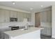 Modern kitchen with gray cabinets, white countertops, and stainless steel appliances at 10341 Fieldstone Myrtle Way, San Antonio, FL 33576