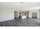 Open concept living area with gray vinyl plank flooring and views into the kitchen at 10341 Fieldstone Myrtle Way, San Antonio, FL 33576