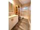 Bathroom featuring shower-tub combo, vanity and tiled floor at 10411 Riverburn Dr, Tampa, FL 33647